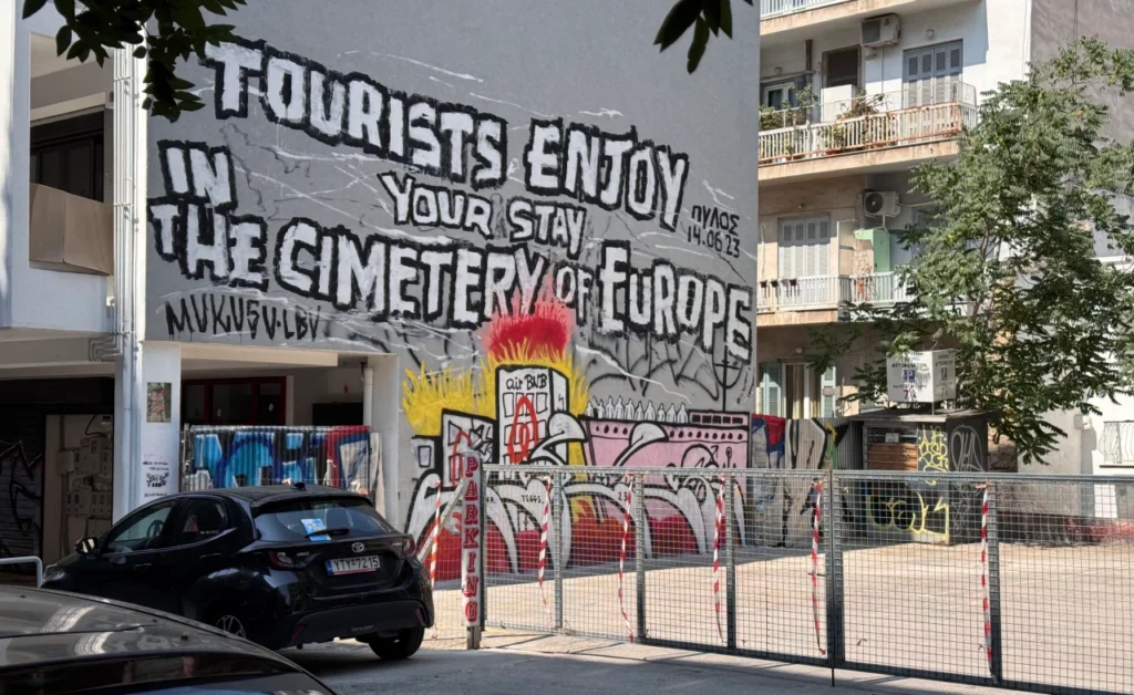 graffiti w Atenach przedstawiające skutki overtourismu - wyludnienie miasta i wyparcie lokalnych mieszkańców na obrzeża