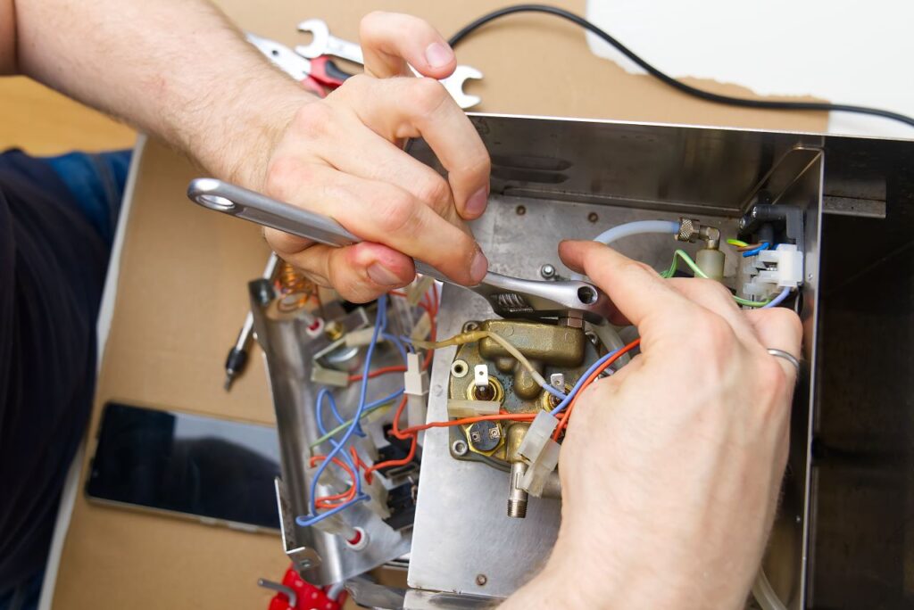 męskie dłonie naprawiają zepsuty sprzęt elektryczny lub elektroniczny